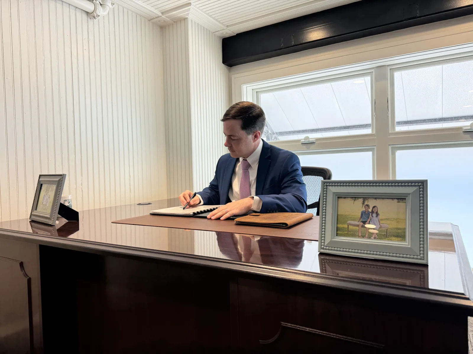 Paul Arceneaux writing at his desk in Thibodaux, Louisiana